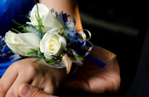 A prom corsage with white and blue flowers
